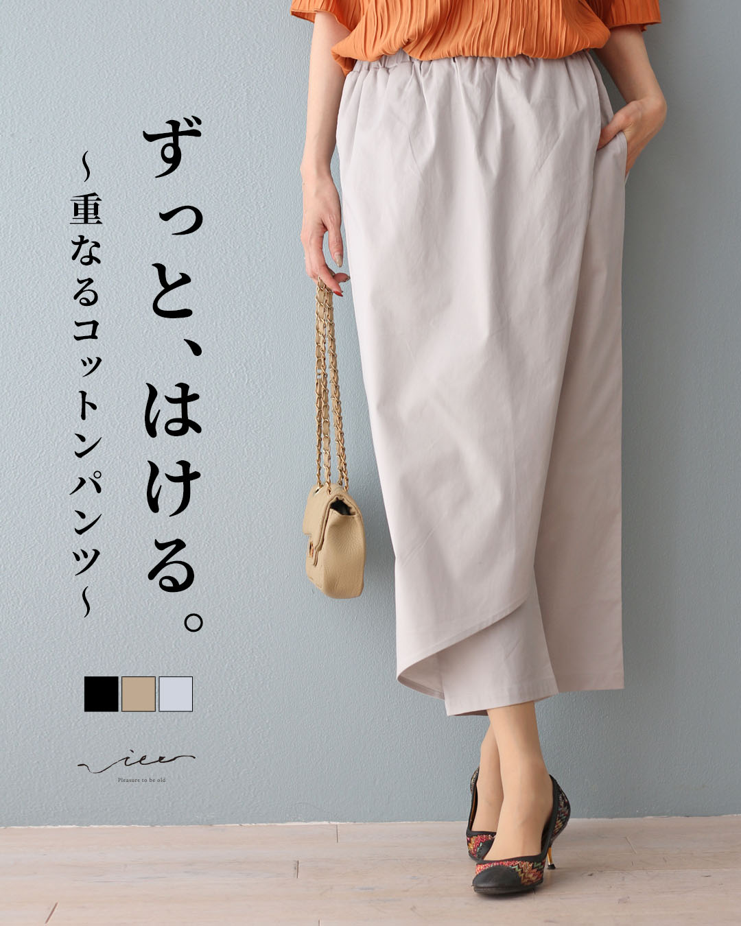 A woman wearing light-colored pants with an orange top and handbag.