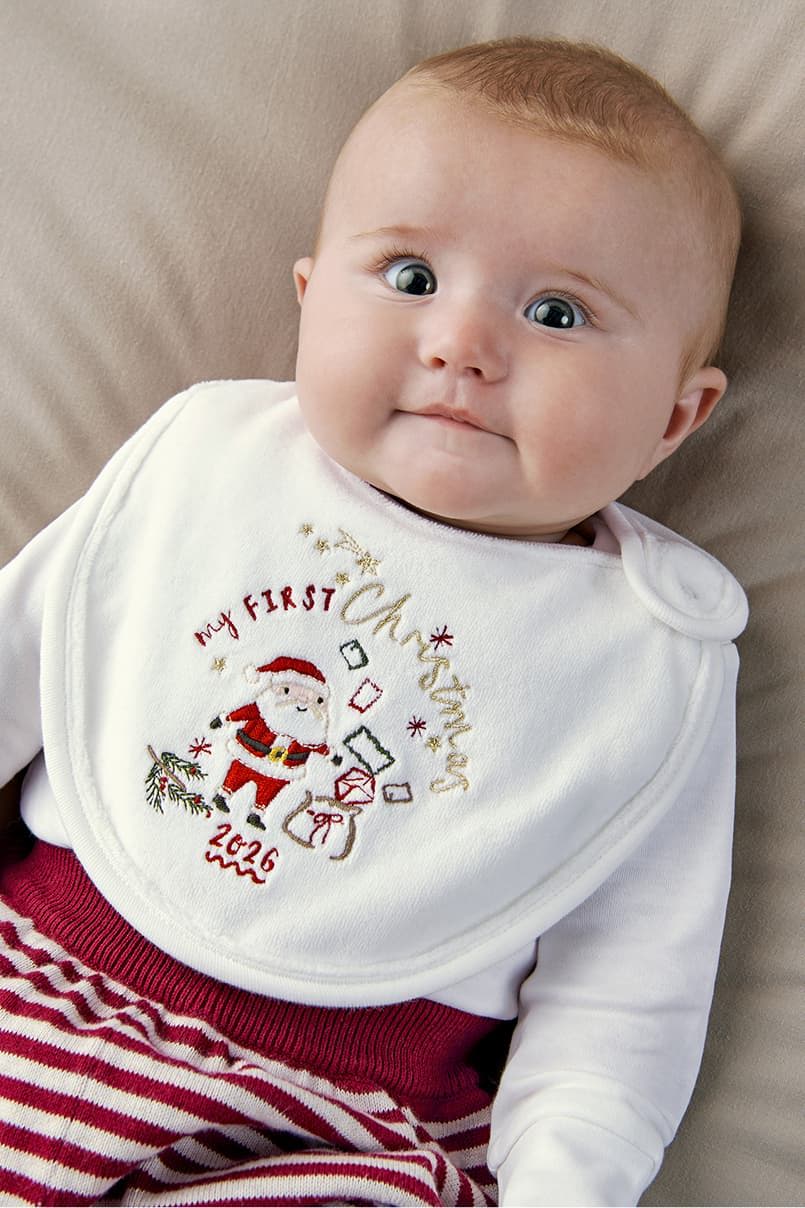 Baby wearing a festive bib with 