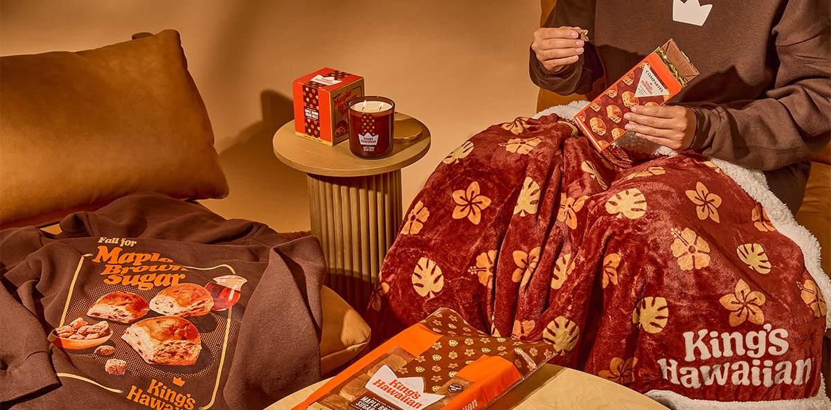 Cozy setup with snacks, blanket, and drinks for a relaxing moment.