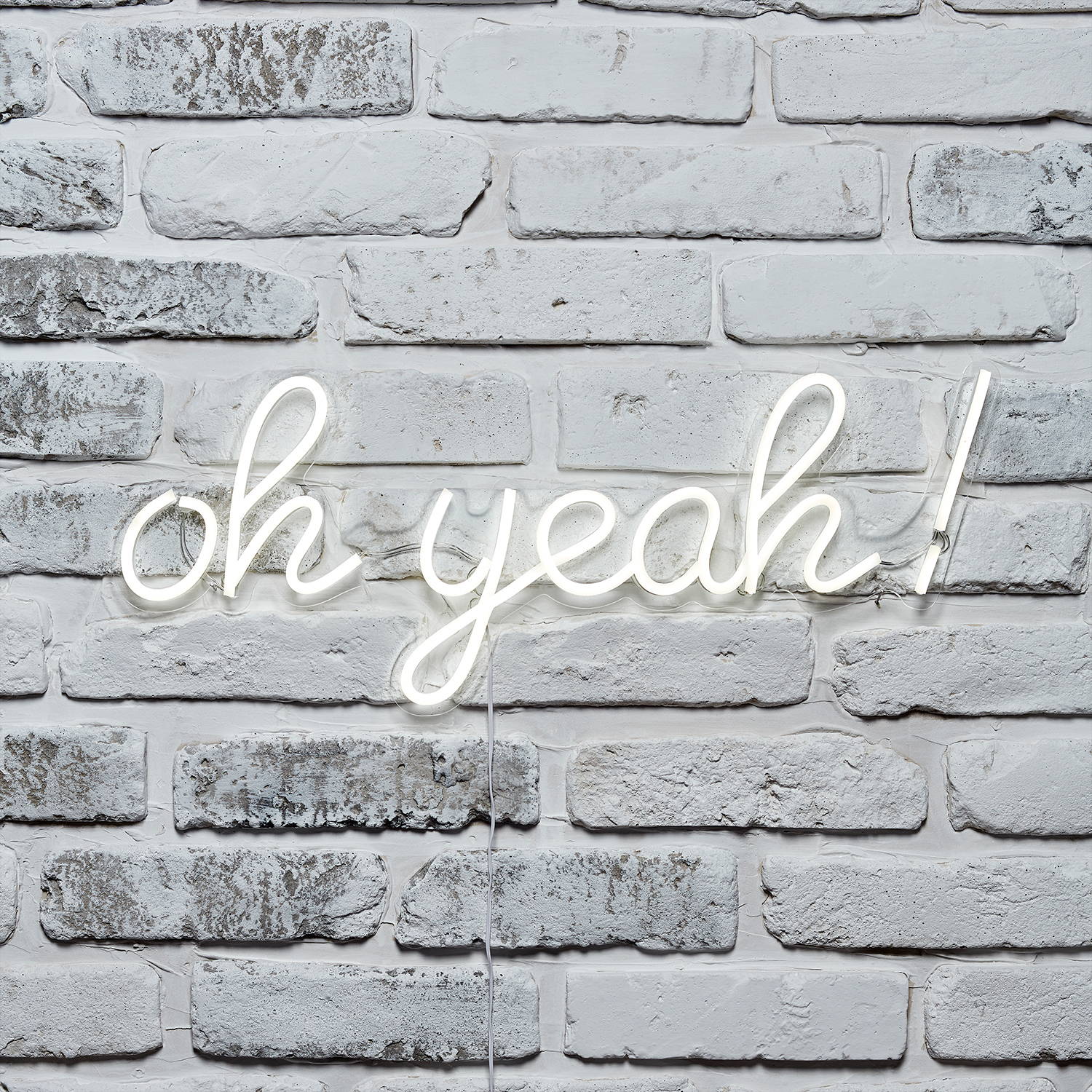 oh yeah! neon wall light on a brick wall