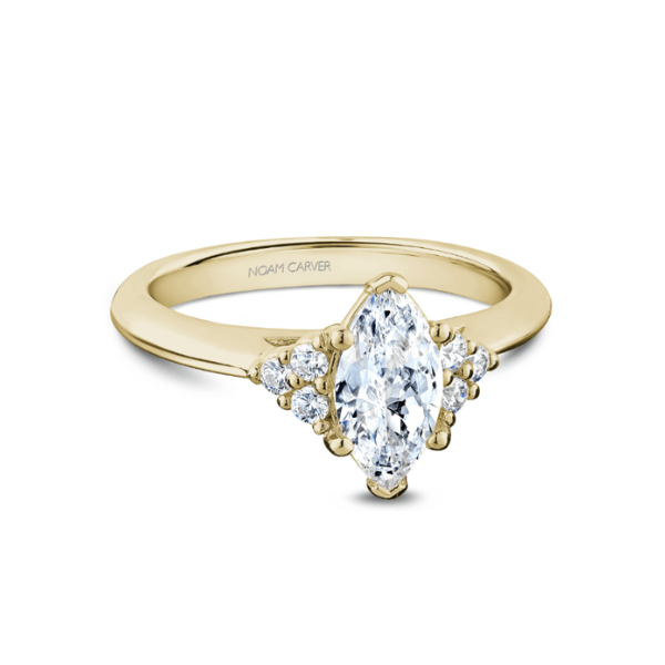 Gold ring with marquise diamond and smaller accent diamonds.