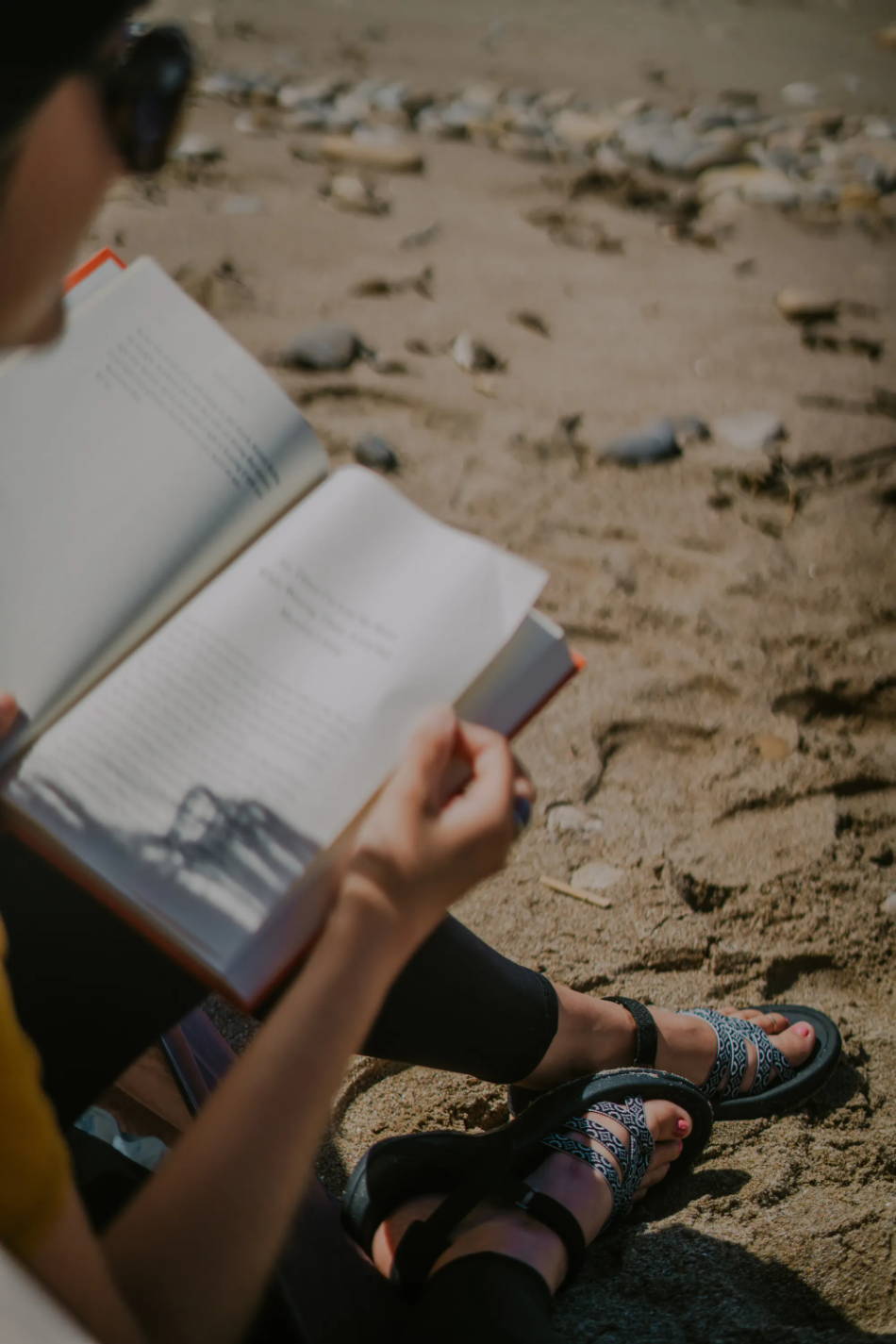 woman reading a book on the beach in the caribbean