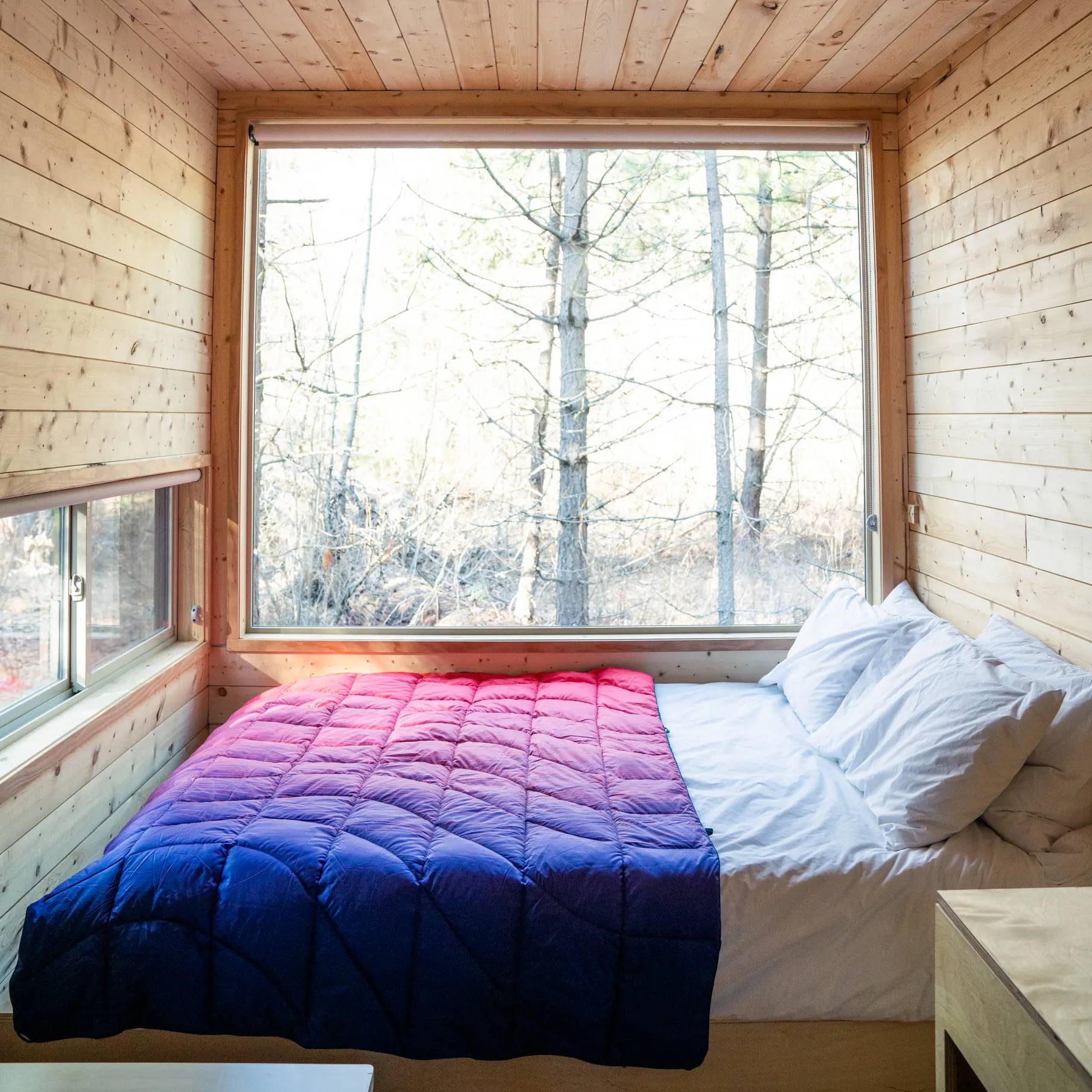 Rumpl Ripple fade blanket on a bed inside a Getaway House