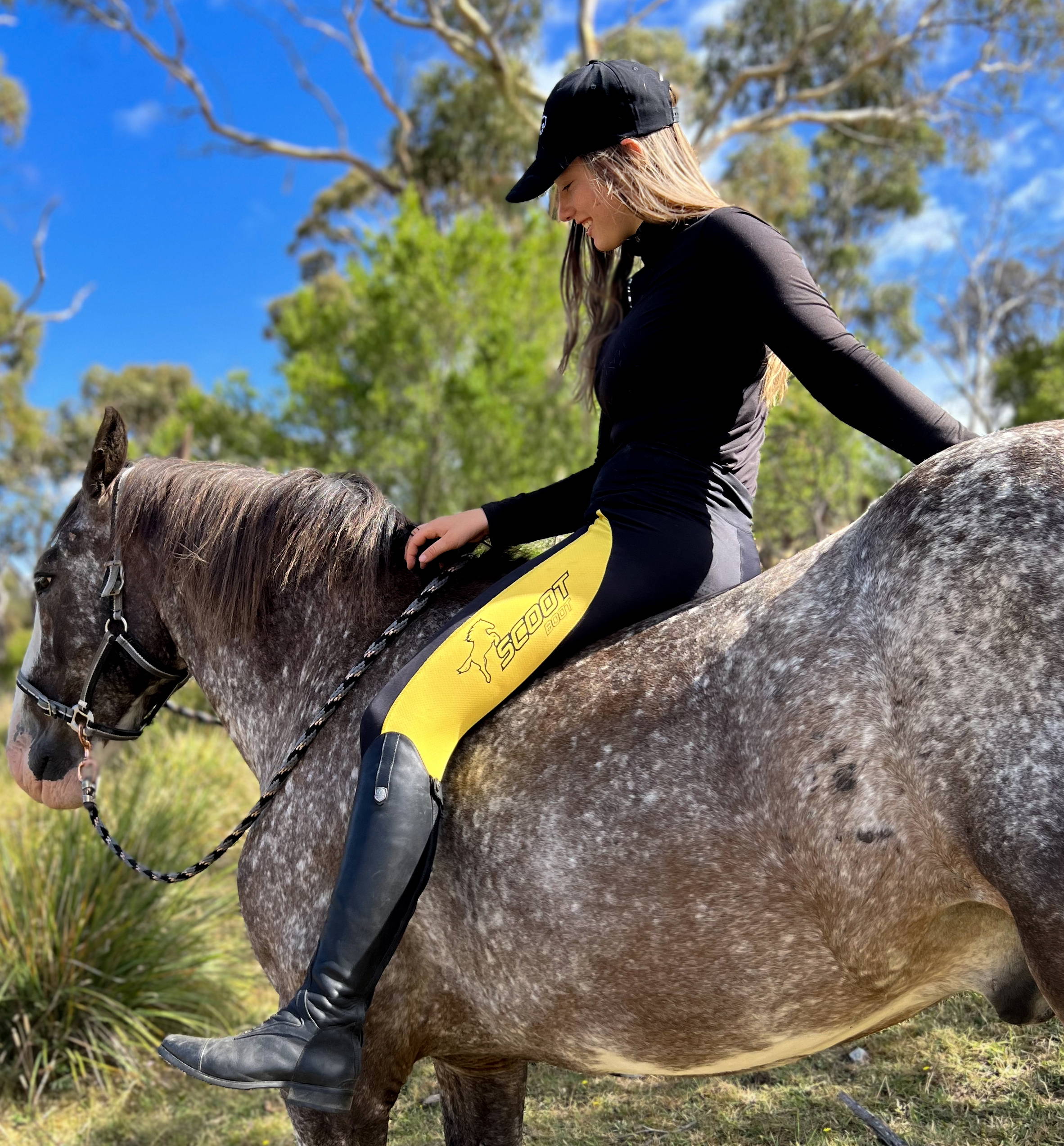 Scootboots equestrian apparel riding gaiters, riding tights, women’ apparel, baseball cap, hoof boots for barefoot horses, female rider on horse.