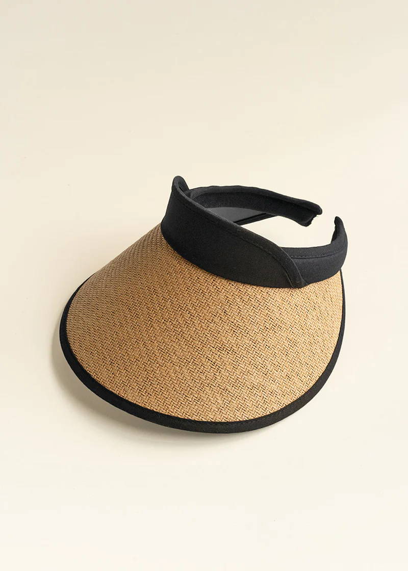 A natural wicker sun visor with black ribbon detailing