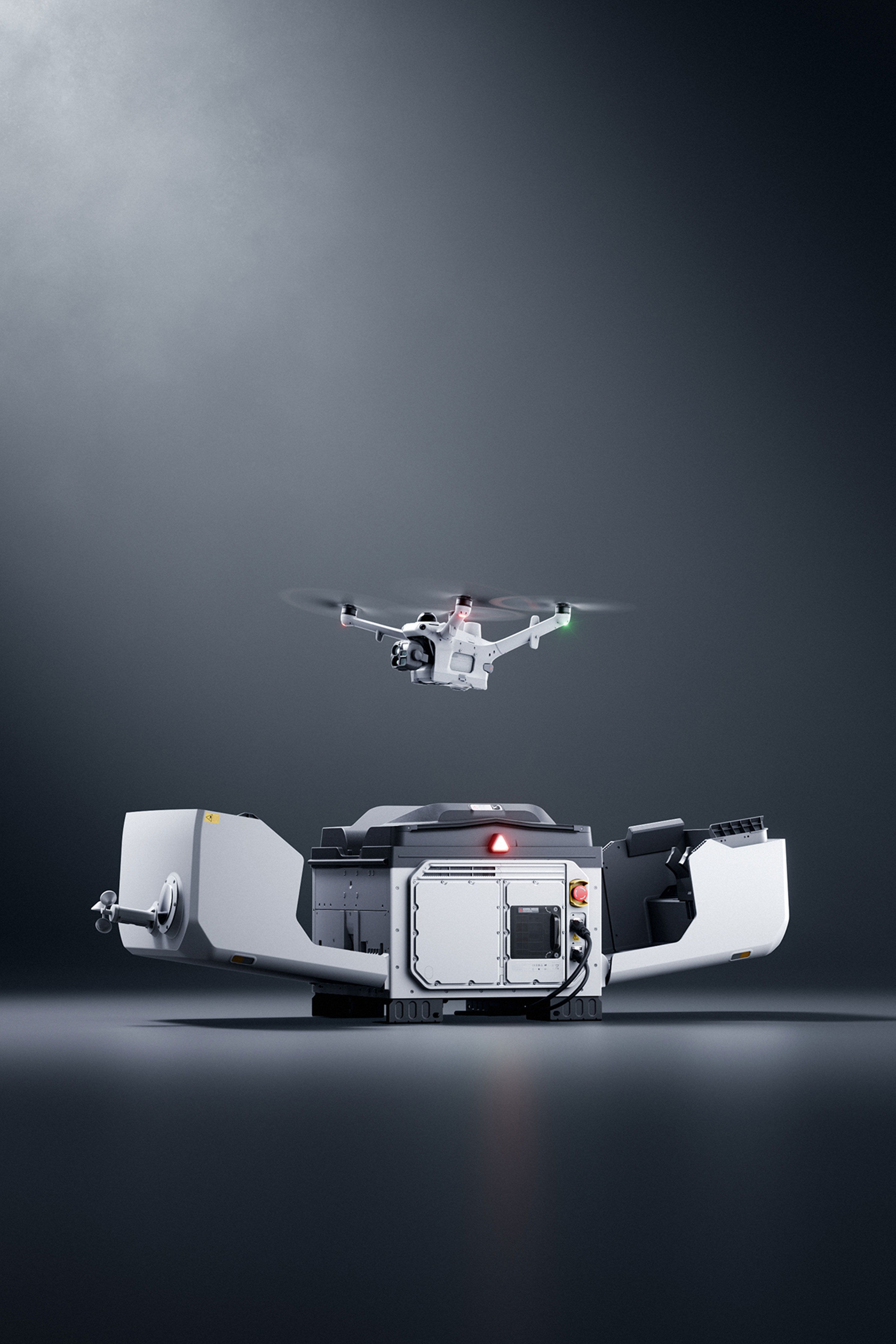A DJI Matrice 4TD drone hovering above a DJI Dock 4 on a dark surface.