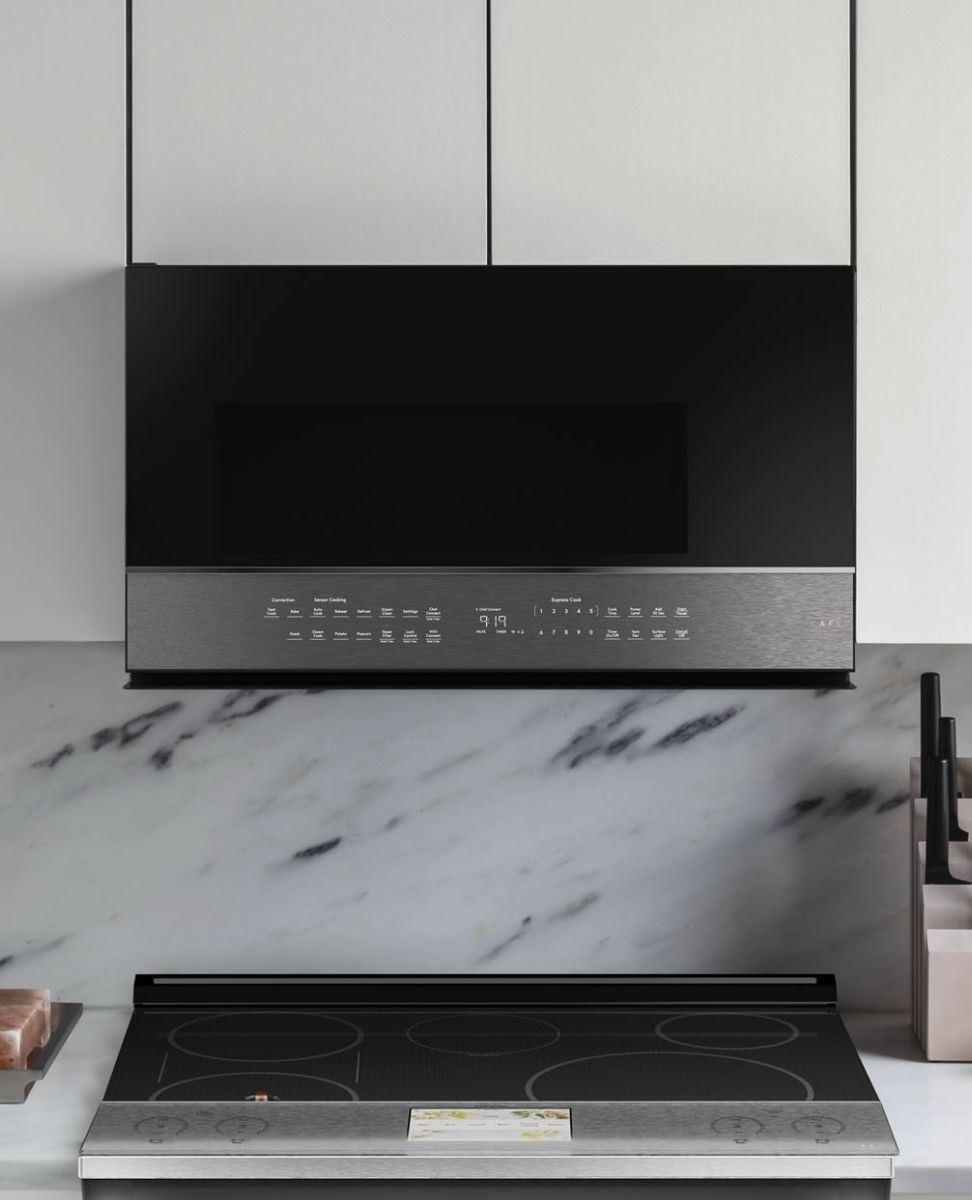 Modern kitchen with a sleek range hood above a cooktop.